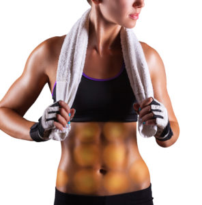 Young sports woman after workout with towel on his shoulders on a dark background
